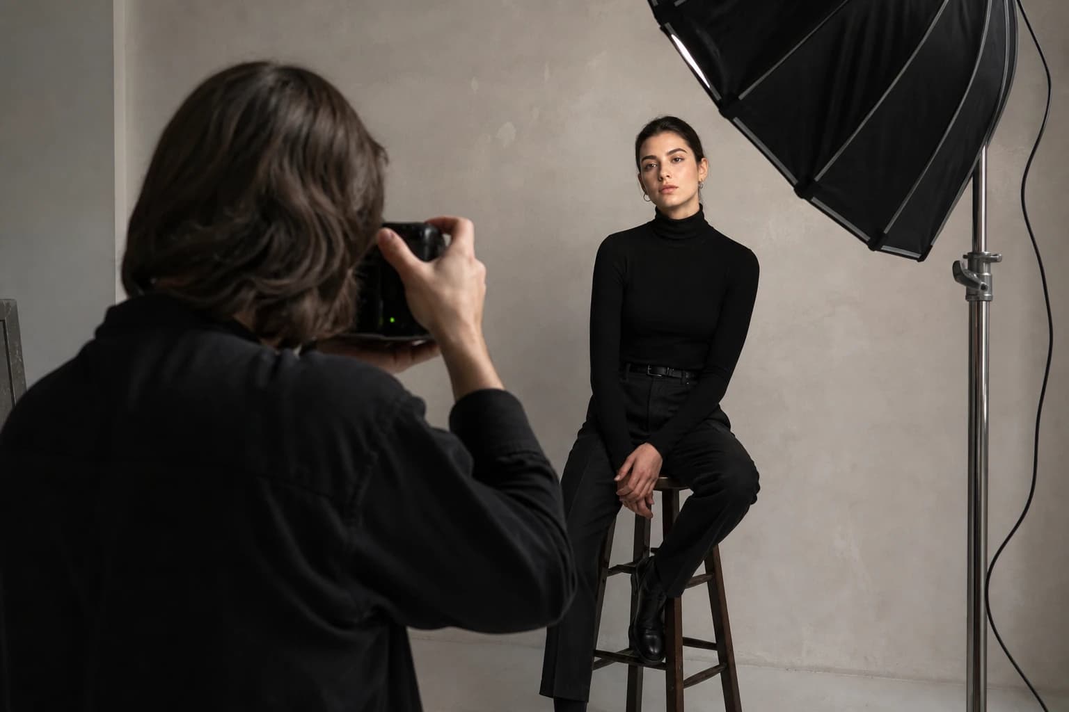Photographer shooting a model under studio light